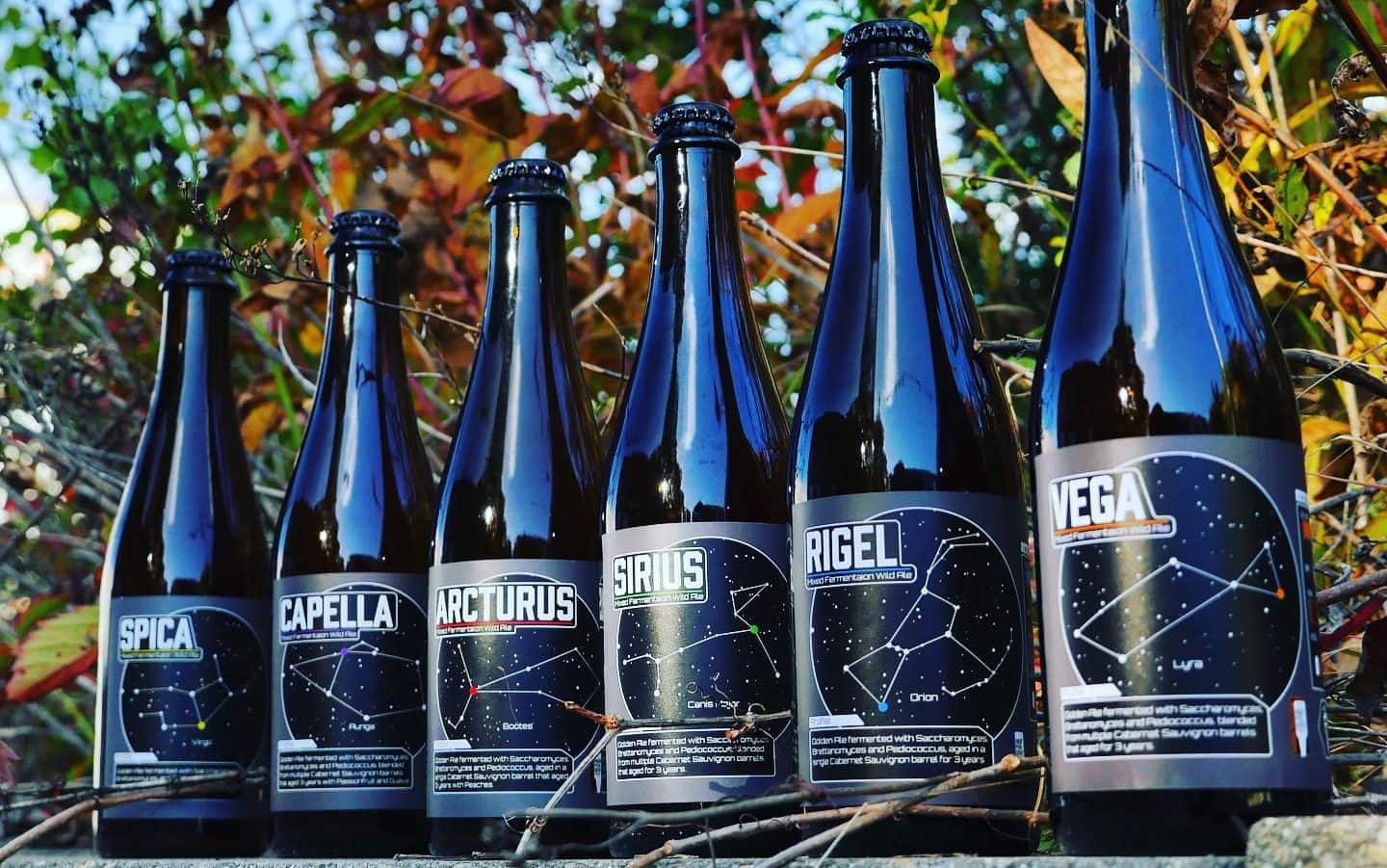 A photo of six bottles of wine barrel aged beers from Empirical Brewery