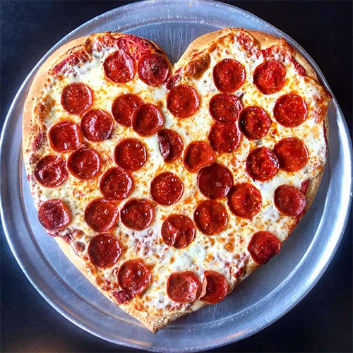 a heart-shaped pepperoni pizza