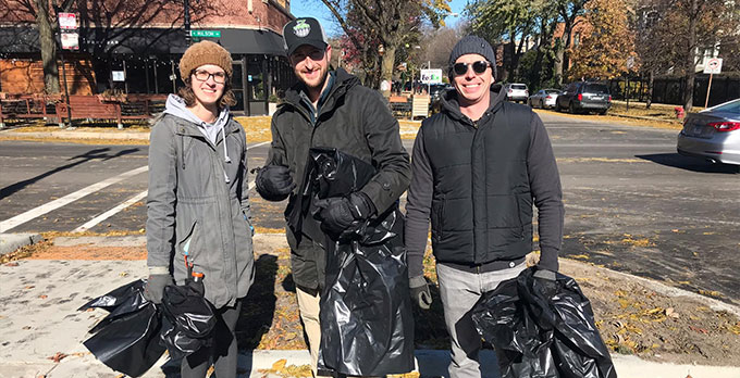 Ravenswood Neighbors Association volunteers pose in the middle of a 2018 year-end neighborhood cleanup  